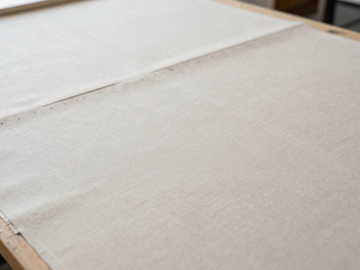 Tailored fabric seams and structured garment construction in a neutral workshop setting
